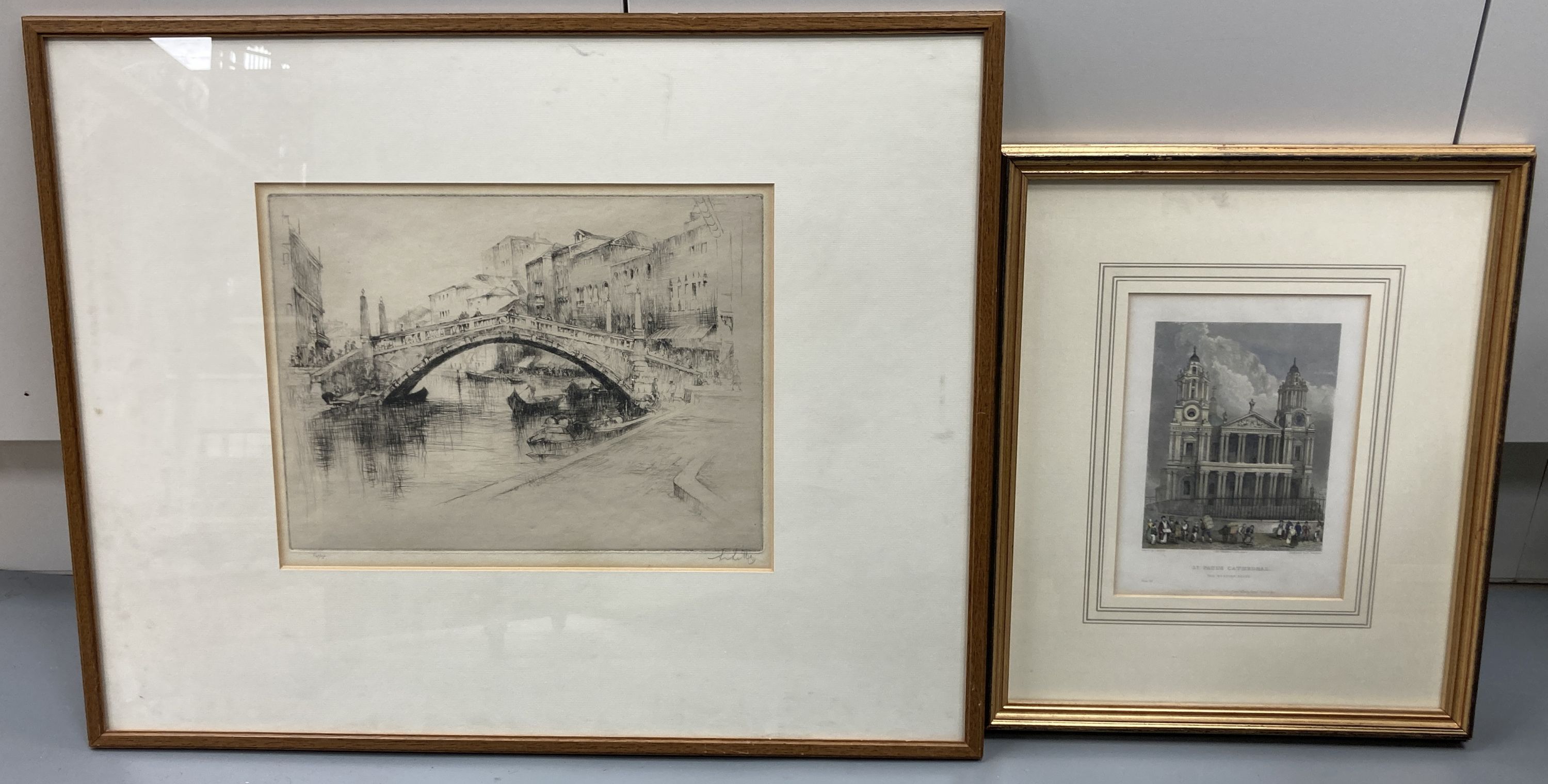 An early 20th century etching of the Rialto Bridge, Venice, indistinctly signed, 22 x 30cm and a coloured engraving of St Pauls Cathed